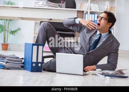 Businessman working and sitting on floor in office Stock Photo