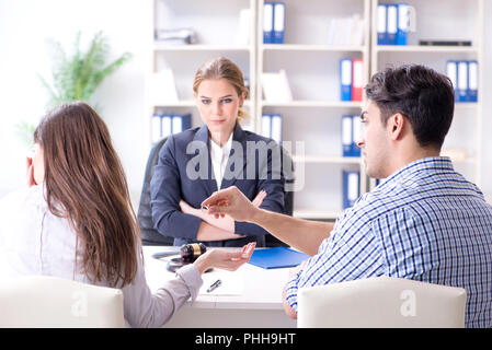 Young family filing divorce papers with lawyer Stock Photo