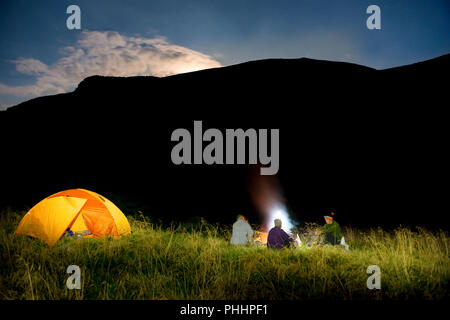 People near illuminated orange tent Stock Photo