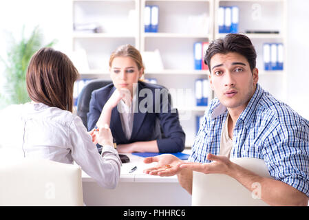 Young family filing divorce papers with lawyer Stock Photo