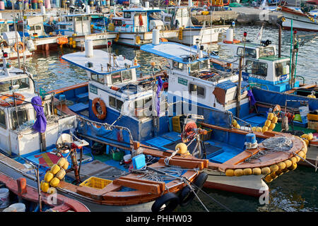 Moored fishing boats in the small harbour in Haeundae Bay, Busan Korea. Stock Photo