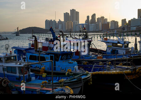 Moored fishing boats in the small harbour in Haeundae Bay, Busan Korea. Stock Photo