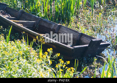 Old rusty abandoned boat on the river shore in nature park Lonjsko polje, Croatia Stock Photo