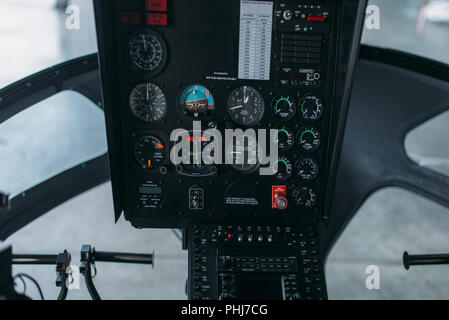 Inside helicopter cabin, control panel, nobody. Dashboard in cockpit of private copter Stock Photo