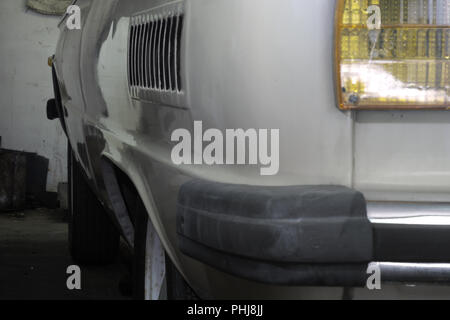 vintage vehicle compact body rear view: bumper with plastic linings, tail turn signal orange, elegantly rounded corner, air intake grille on left side Stock Photo