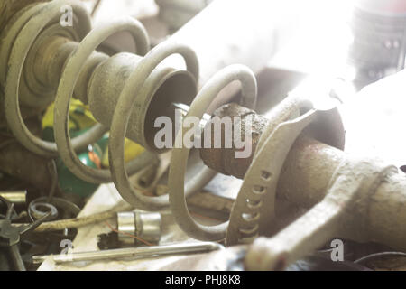front air spring, car repairing. working and spare parts and tools laid on workbench prepared for service to reinstall Stock Photo