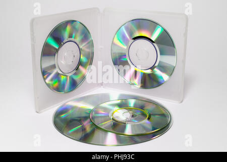 case for mini CDs. inner trays of double-sided semitransparent plastic box with iridescent discs on clips and the stack of different sizes discs Stock Photo