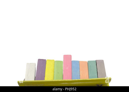 chalks for drawing colored set take out from open cardboard box. children creativity pieces on cyan background with clipping path Stock Photo
