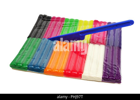 wax fluorescent plasticine of twelve colors set with a modeling tool, stuck in transparent pack ; isolated group of objects Stock Photo