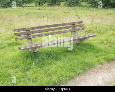 Bench seat in an empty public space. For Covid-19 lockdown, park bench reunions, empty seats during Covid in UK. Stock Photo