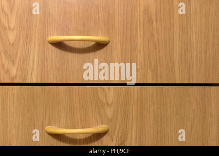 wooden drawers with graceful slim pull handles. Furniture for anteroom. bow-type. arcs of shadows Stock Photo