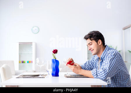 Man alone preparing for romantic date with his sweetheart Stock Photo
