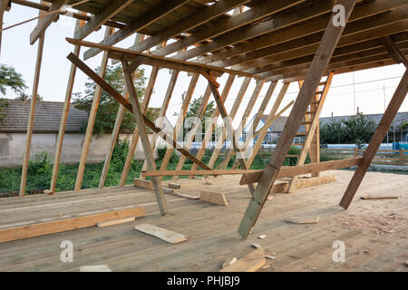 New construction home framing against blue sky at sunser, closeup of ceiling frame. Stock Photo