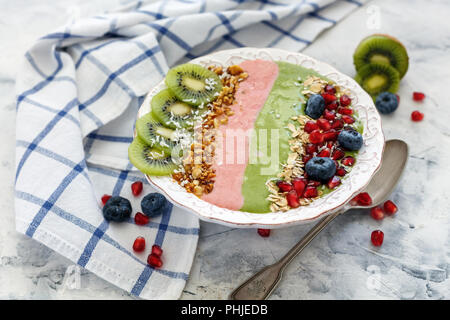 Smoothies bowl of spinach and strawberries with berries and fruit. Stock Photo
