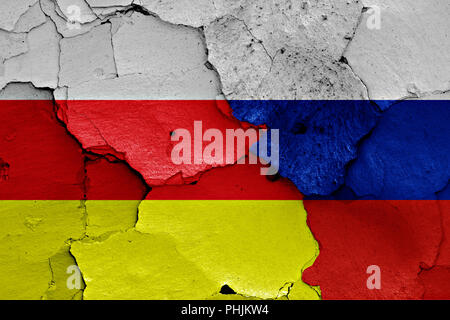 flags of North Ossetia and Russia painted on cracked wall Stock Photo