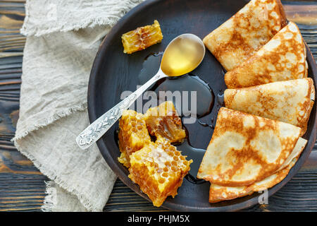 Crepes and honey for a delicious breakfast. Stock Photo