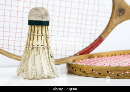 Old badminton accessories on a light table. Set for outdoor games and games. White background. Stock Photo