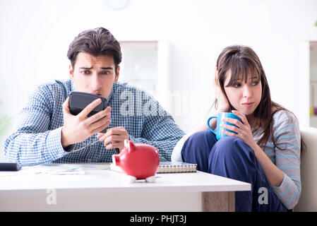 Young couple looking at family finance papers Stock Photo