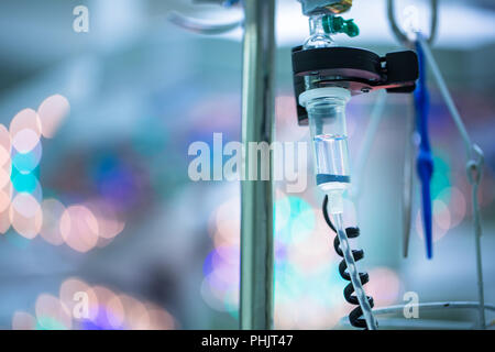 Drip irrigation equipment in hospital surgery room by the operations table, conceptual image - lovely blurred background Stock Photo