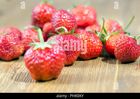 red berries of a large strawberry grown in a private area near the house, berries without nitrates Stock Photo