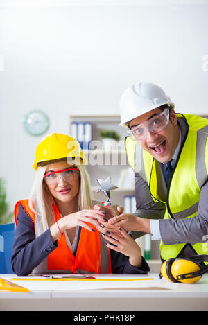 Construction workers having discussion in office before starting Stock Photo