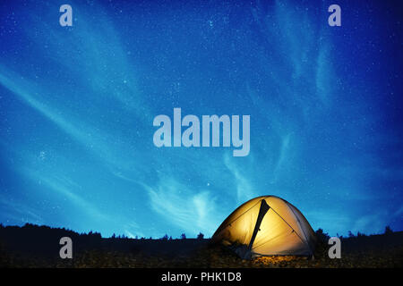 Illuminated yellow camping tent Stock Photo