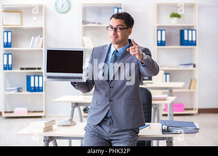 Young handsome businessman employee working in office at desk Stock Photo