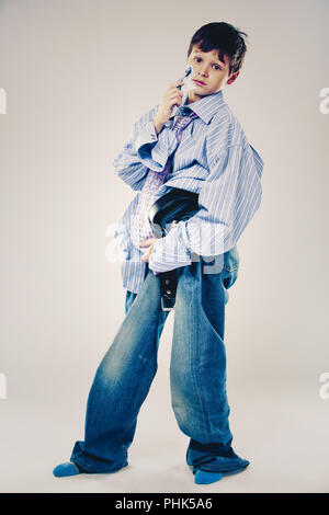 funny boy wearing Dad's clothes Stock Photo