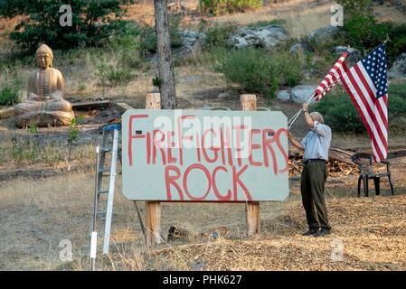 A resident shows his support for firefighters as they battle the Taylor Creek and Klondike fires burning in the Rogue River Siskiyou National Forest August 11, 2018 near Grants Pass, Oregon. Stock Photo