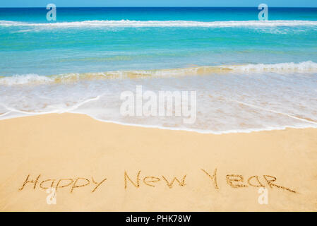 Happy New Year message on the beach Stock Photo
