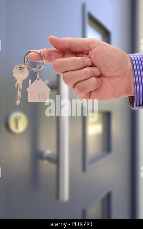 key for new home in hand of real estate agent Stock Photo