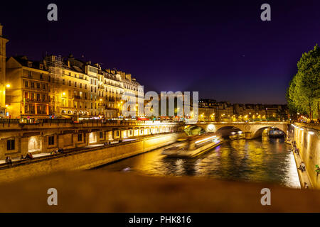 A long exposure, night photo of the river Seine in Paris. Stock Photo