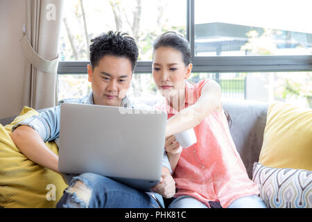 Young Couples using laptop Stock Photo