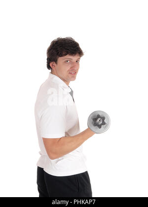 Young man standing in profile lifting dumbbell Stock Photo