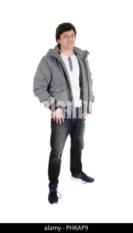 Young man standing in jacket and jeans Stock Photo