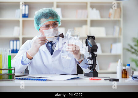 Forensics investigator working in lab on crime evidence Stock Photo