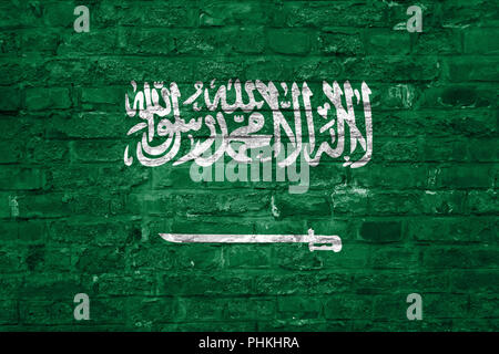 Flag of Saudi Arabia over an old brick wall background, surface Stock Photo