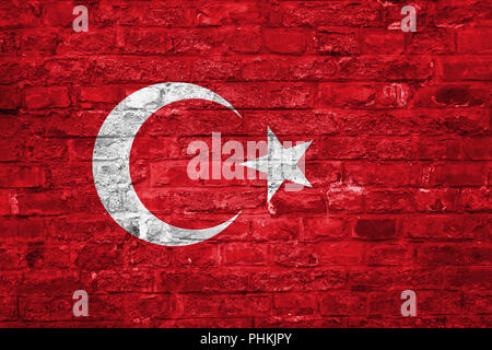 Flag of Turkey over an old brick wall background, surface Stock Photo