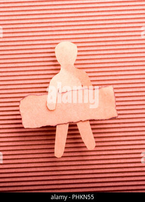 Paper man shape holding burnt note paper in hand Stock Photo