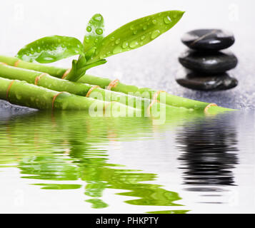 Japanese Zen garden with stacked stones mirroring in water Stock Photo