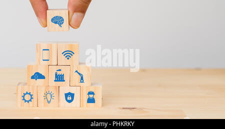 smart factory, industry 4.0 futuristic technology trend concept, Hand man put the icon to connect, icons including wifi, ai ,artificial intelligence,  Stock Photo