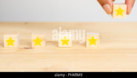 business successful concept, hand man try to put the the fifth star to complete five star rating to the business or service  customer experience , the Stock Photo