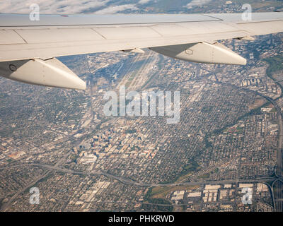 Airplane Making Turn With San Jose Airport in the background Stock Photo