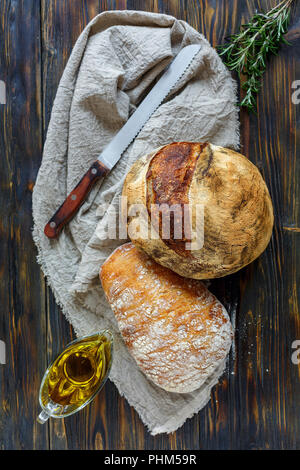 Freshly baked bread on linen cloth. Stock Photo