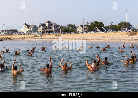 The 'Polar Bears' gather for a morning swim, exercise, and prayer in the water off Inkwell Beach in Oak Bluffs, Massachusetts on Martha's Vineyard. Stock Photo