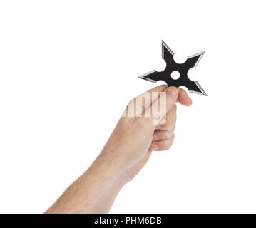 Hand is throwing ninja shuriken Stock Photo