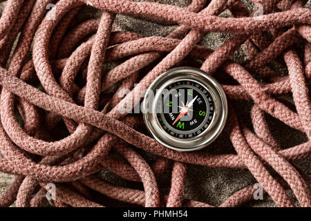 compass isolated on old ropes - closeup Stock Photo