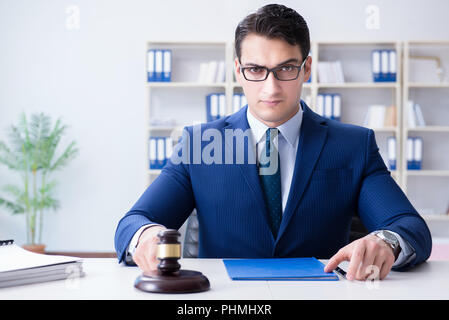 Young lawyer judge sitting in the office Stock Photo