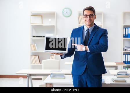 Young handsome businessman employee working in office at desk Stock Photo