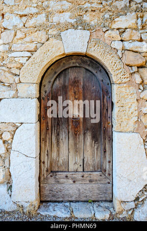 Brown shabby wood old door in an old building Stock Photo